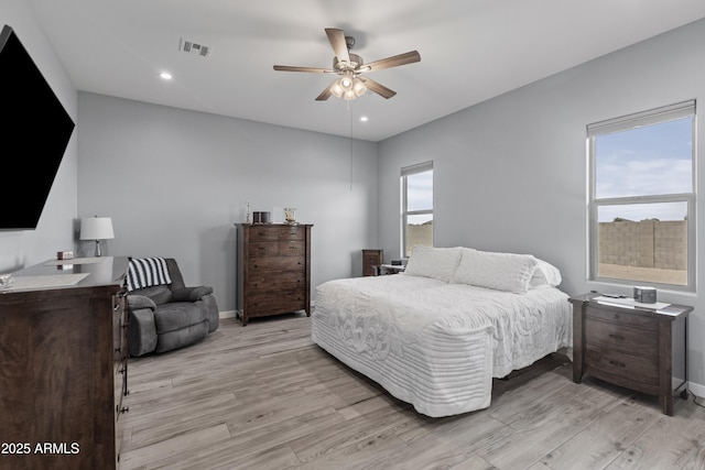 bedroom featuring light wood finished floors, visible vents, recessed lighting, and baseboards