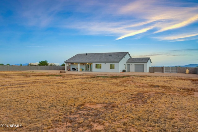 back of property with a garage and fence