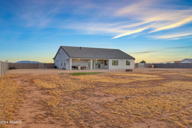 back of house featuring stucco siding, a fenced backyard, and a patio area