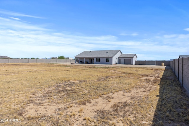 exterior space featuring a fenced backyard and a garage