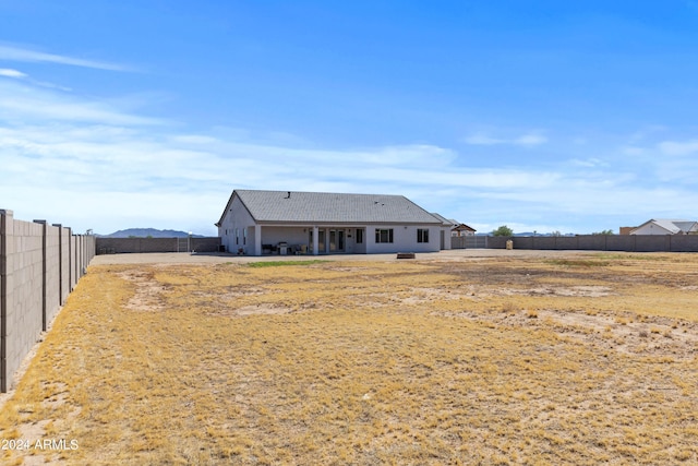 rear view of property with a fenced backyard