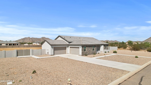 view of front of property featuring a gate, fence, a mountain view, and driveway