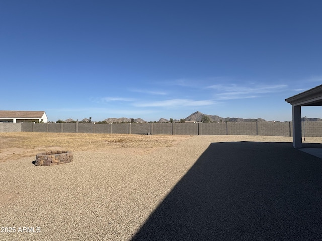 view of yard featuring a fenced backyard and an outdoor fire pit