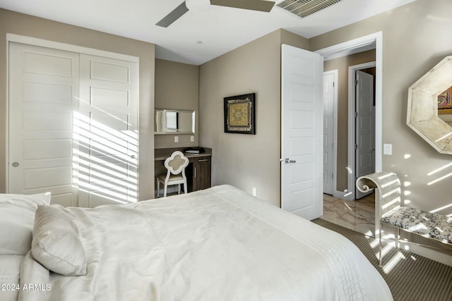 bedroom featuring ceiling fan and a closet