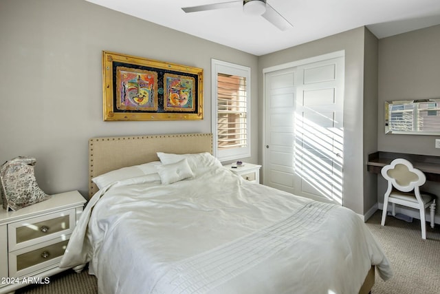 carpeted bedroom featuring a closet and ceiling fan