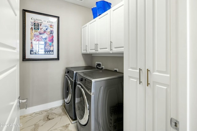 washroom featuring washer and clothes dryer and cabinets