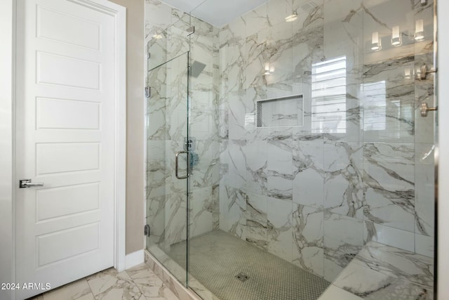 bathroom with a shower with shower door