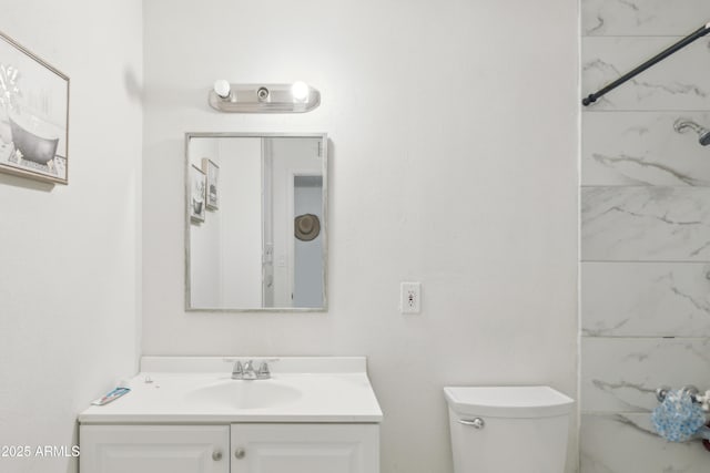 bathroom featuring toilet and vanity