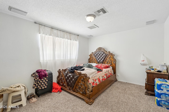 carpeted bedroom featuring visible vents and a textured ceiling