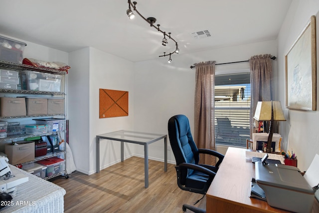 office area featuring hardwood / wood-style flooring and track lighting