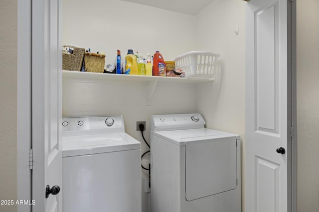 washroom featuring washer and clothes dryer