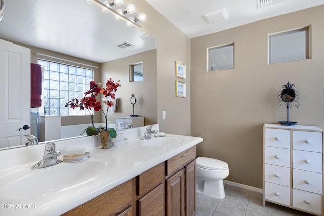 bathroom with tile patterned floors, vanity, and toilet