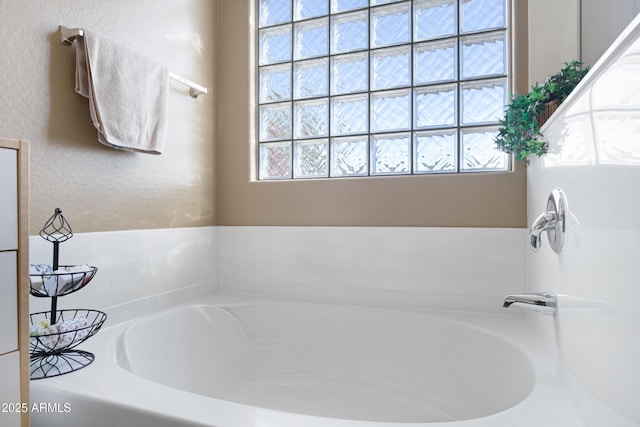 bathroom with a bath and a wealth of natural light