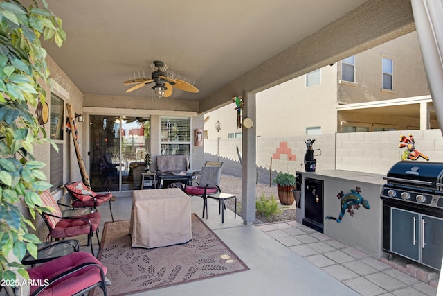 view of patio featuring ceiling fan and exterior kitchen