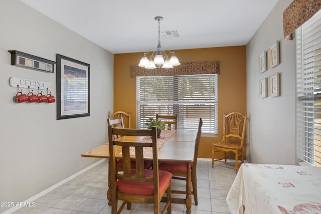 tiled dining area with an inviting chandelier