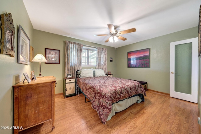 bedroom featuring light wood-style flooring, baseboards, and ceiling fan
