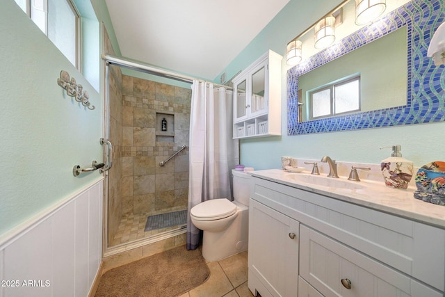 full bath featuring a stall shower, toilet, vanity, and tile patterned floors