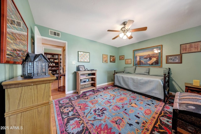 bedroom with baseboards and wood finished floors