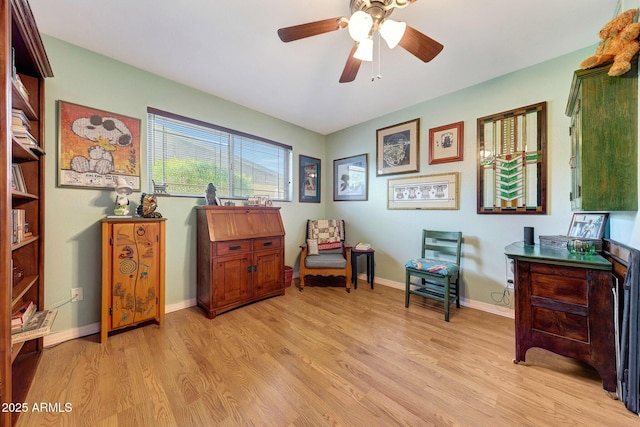 sitting room with light wood-type flooring, ceiling fan, and baseboards