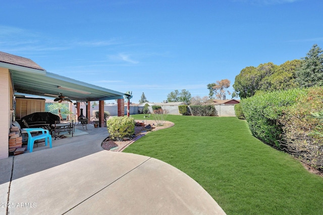 view of yard with a patio area and ceiling fan