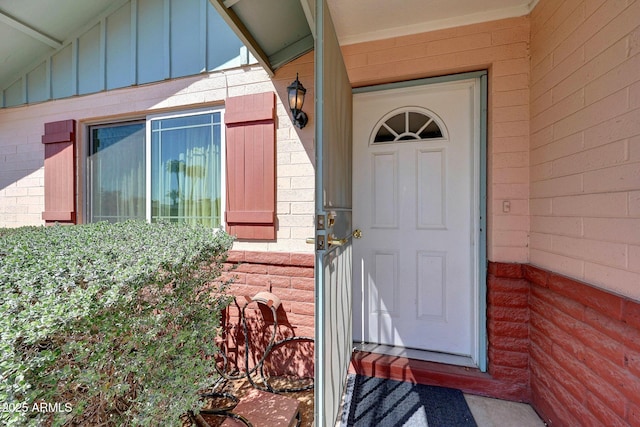doorway to property featuring board and batten siding