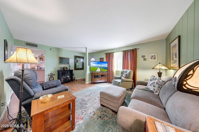 living area with wood finished floors and baseboards