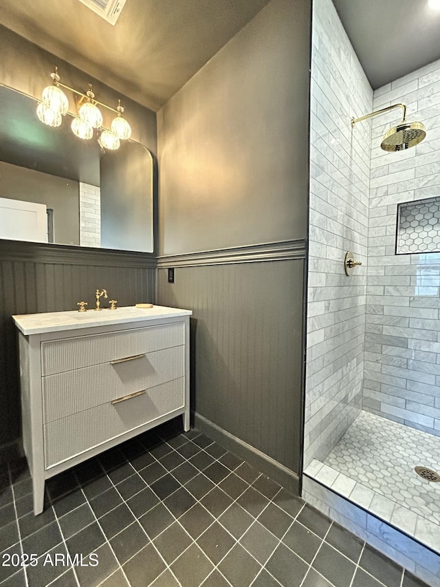 1551 W Vernon Ave, Phoenix, AZ 85007 - bathroom featuring tile patterned floors, a tile shower, wainscoting, and vanity