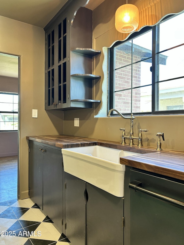 1551 W Vernon Ave, Phoenix, AZ 85007 - kitchen featuring light tile patterned flooring, a sink, and glass insert cabinets