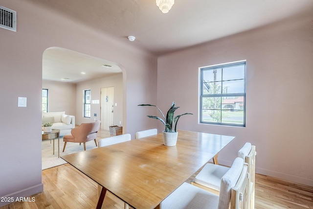 1551 W Vernon Ave, Phoenix, AZ 85007 - dining room featuring arched walkways, baseboards, and wood finished floors
