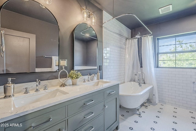 1551 W Vernon Ave, Phoenix, AZ 85007 - bathroom with a freestanding bath, double vanity, curtained shower, and tile patterned floors