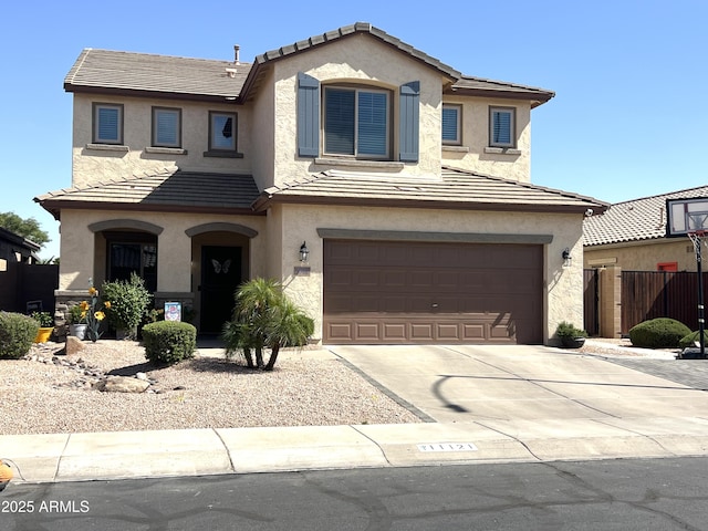 view of front of property featuring stucco siding, an attached garage, and a tile roof