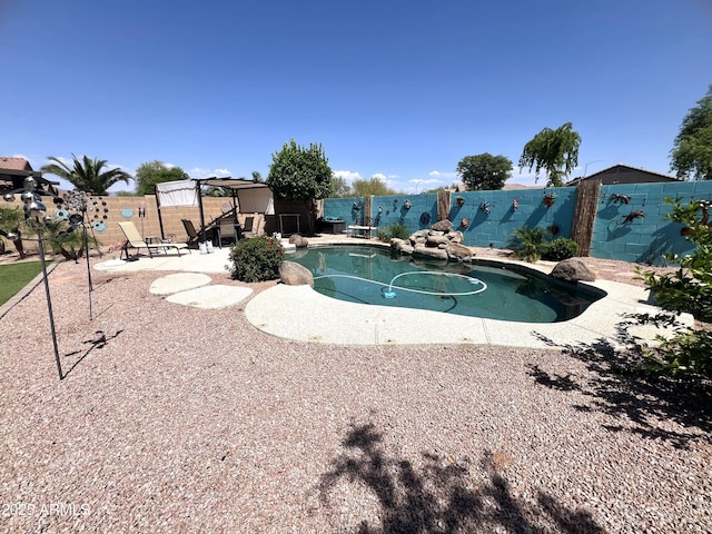 view of pool featuring a patio, a fenced in pool, and a fenced backyard