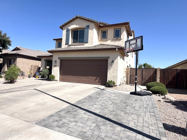 traditional home with fence, a garage, stucco siding, a gate, and driveway