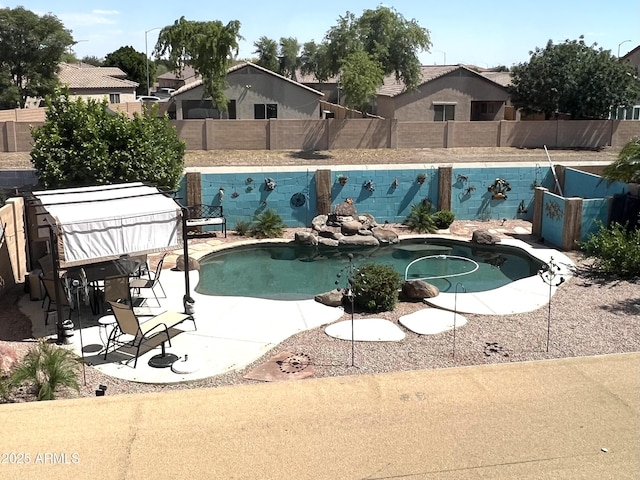 view of swimming pool featuring a patio, a fenced backyard, and a fenced in pool