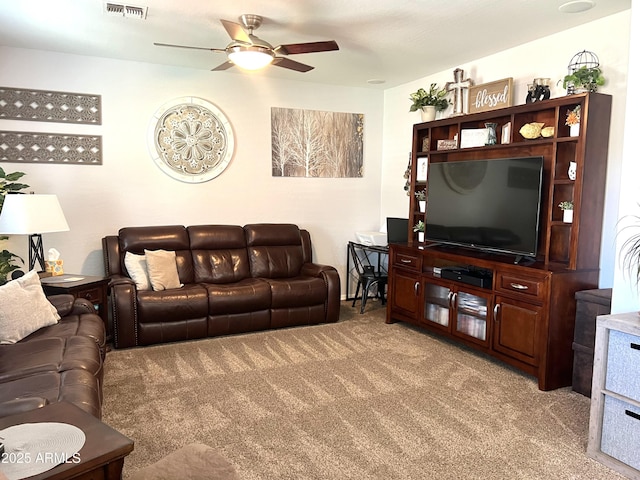 living room with light colored carpet, ceiling fan, and visible vents