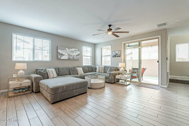 living room with ceiling fan, a healthy amount of sunlight, and light hardwood / wood-style floors