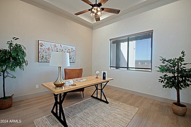 home office featuring light hardwood / wood-style floors and ceiling fan