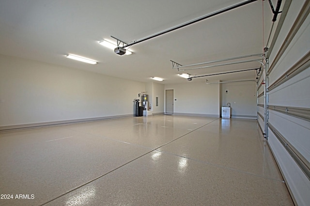 garage with water heater and a garage door opener