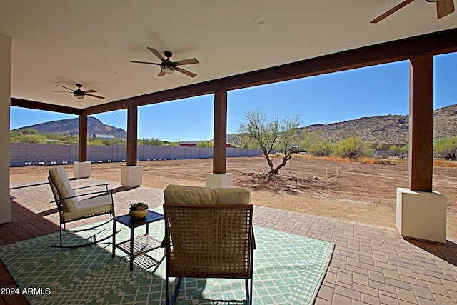 view of patio featuring a mountain view and ceiling fan