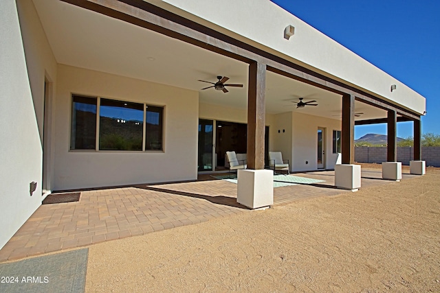 view of patio / terrace with a mountain view and ceiling fan