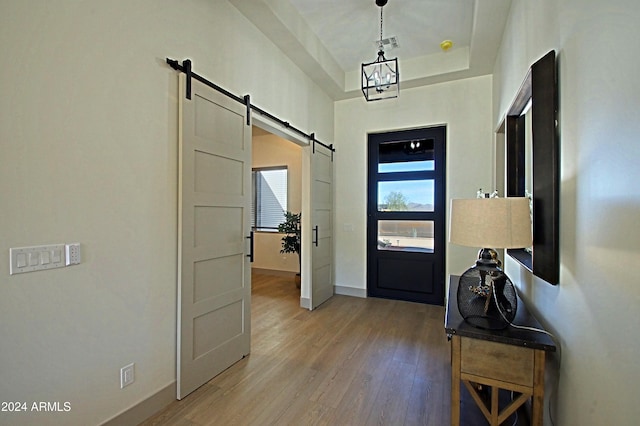 interior space featuring a barn door and hardwood / wood-style floors