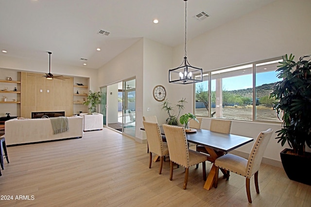 dining area with light hardwood / wood-style floors and ceiling fan