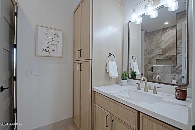 bathroom featuring vanity and tiled shower