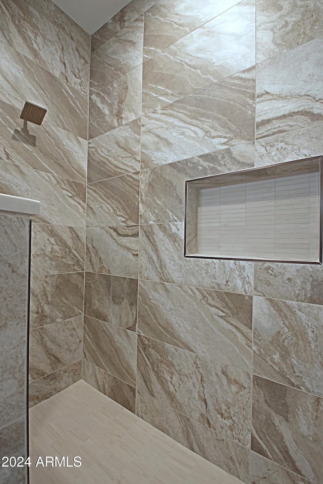 bathroom featuring tiled shower