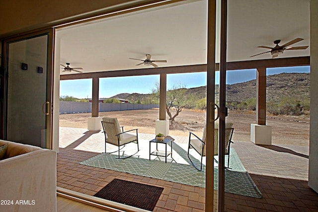 view of patio / terrace featuring ceiling fan and a mountain view