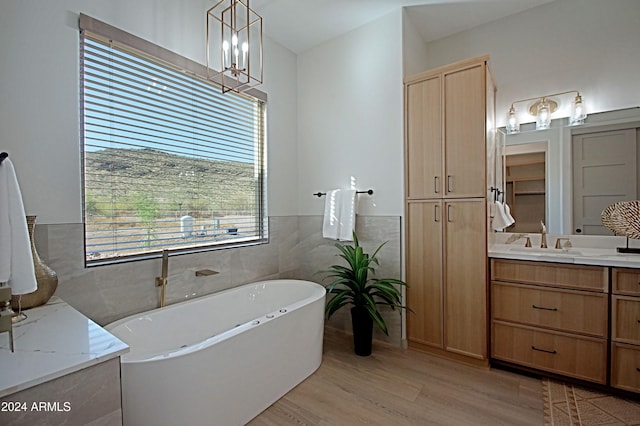 bathroom with vanity, hardwood / wood-style flooring, tile walls, and a washtub