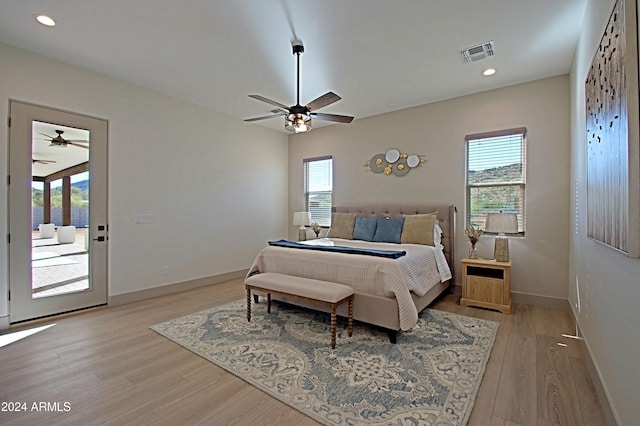 bedroom with access to outside, multiple windows, light hardwood / wood-style flooring, and ceiling fan