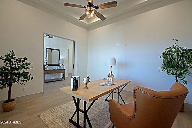 office space with light hardwood / wood-style floors and ceiling fan