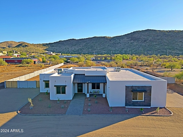 view of front facade featuring a patio and a mountain view