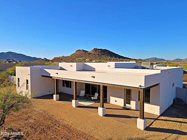 back of property featuring a patio and a mountain view